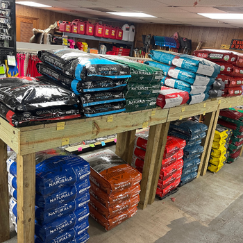 Bags of feed on a counter inside of Florida Farm & Ranch.