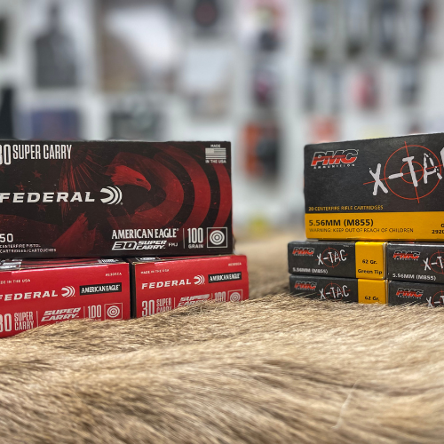 Boxes of PMC and Federal ammunition displayed.
