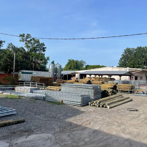 A parking lot full of farm fencing and gate materials.